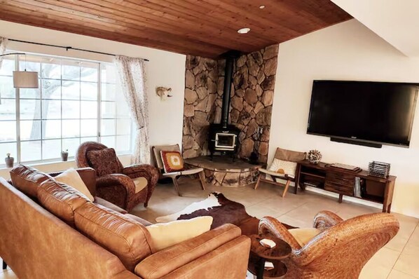 Living Room features wood burning stove and large window with inspiring views.