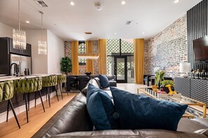 Living Room opens up to pool. Features queen-size sleeper sofa.