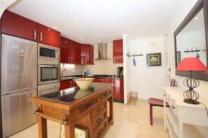 Modern kitchen in this apartment is fully equipped with all the appliances