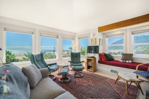 Oceanview living room with streaming tv w/ basic channels, reading nook, electric piano, and hideabed. Access to deck with ocean view .