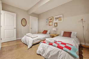 2nd bedroom with twin beds and walk-in closet.