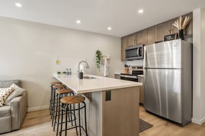 Fully loaded kitchen with fridge, microwave and all essential dinnerware