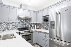 Whip up a feast in our fully-equipped kitchen, boasting a spice rack, ice maker, modern appliances, and a coffee machine for your morning brew.