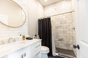 Our floor to ceiling marble shower includes Public Goods shower products for you to use during your stay!