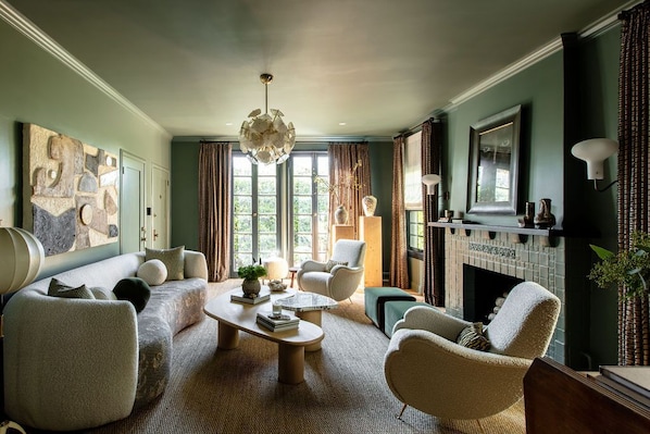 Sophisticated and colorful living room with decorative fireplace, smart tv