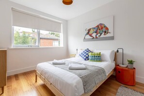 The lovely and spacious second bedroom is furnished with a double bed and built-in wardrobes for ample storage.