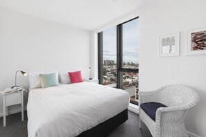 The second bedroom is spacious, with a wardrobe, queen bed and more scenic views of Melbourne and the Dandenong Ranges