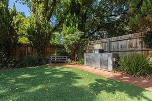 The building offers ample outdoor space, with BBQ facilities and a picnic area.
