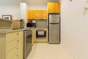 A fully-equipped kitchen complete with  a microwave, full-sized fridge, dishwasher, electric stovetop, an oven and all the cooking basics you’ll need
