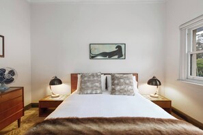 The first bedroom is fitted with a queen-sized bed and topped with crisp white linen. There is ample storage space for both long and short term stays.