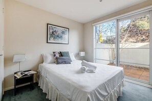  The queen-sized bedroom offers access to the patio through large sliding doors and comes with built-in wardrobes with plenty of room for your belongings.
