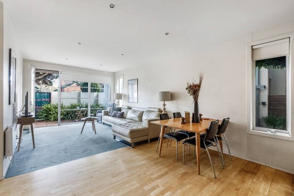 The open-plan dining and living room extends to the patio, creating a seamless transition with the outdoors.