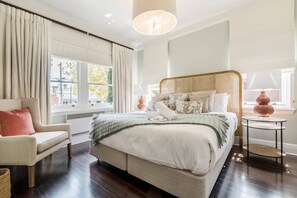 The spacious, light-filled master bedroom offers a king-size bed as well as a comfy armchair to settle in with an evening read. 
