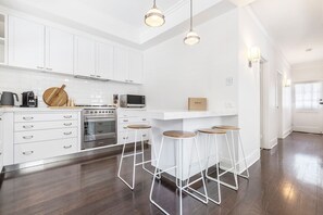 The kitchen offers seating around the breakfast bar for casual dining and socialising. 