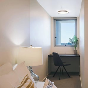 This charming work desk has a large window with city views, perfect for creating a calm and peaceful environment for getting daily tasks done. 