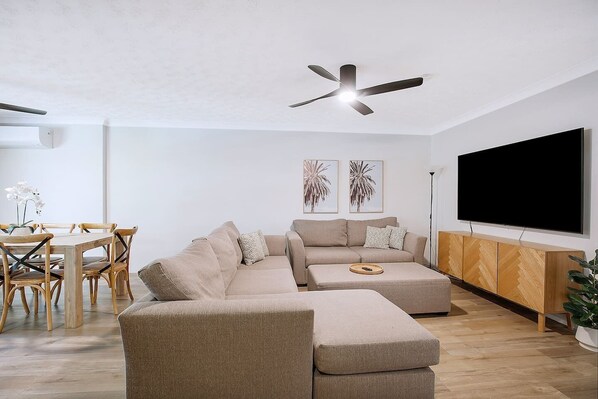 Relax in the open-plan living area, complete with a generous sofa inviting you to settle in with a movie.
