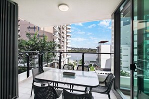 Enjoy dining outside with ease. The balcony glass table seats six and sits under cover and outdoor lighting. 
