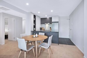 An inviting, open-plan layout includes a four-seater table for relaxed dining at home. 