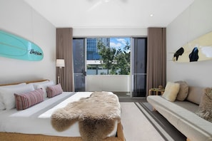 The king-sized primary bedroom is a sumptuous retreat with a sofa.