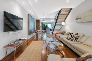 Get comfortable on the oversized lounge, enjoying the large wall-mounted TV.