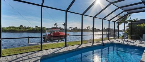 Lovely South Gulf home with sparling pool overlooking canal