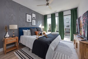 Primary bedroom with King bed, smart TV, large walk-in closet, and ensuite jack-and-jill bathroom with shower/tub combo.