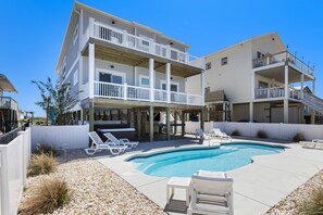Escape to Shore Foundation's oasis, where nature's beauty surrounds you. Relax by the pool, steps from sandy shores.