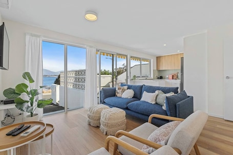Step into a spacious living room designed for relaxation and entertainment. With floor-to-ceiling windows, this room bathes in natural light and offers captivating views.