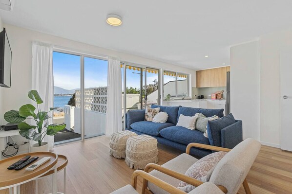 Step into a spacious living room designed for relaxation and entertainment. With floor-to-ceiling windows, this room bathes in natural light and offers captivating views. 