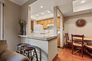 Powderwood 11C: Cozy bar stools by the kitchen bar table, perfect for breakfast.