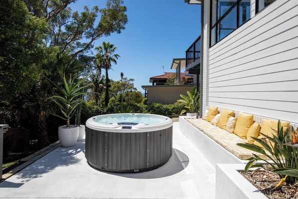 Relax with a dip in the outdoor spa, then take it easy on the sun lounge.
