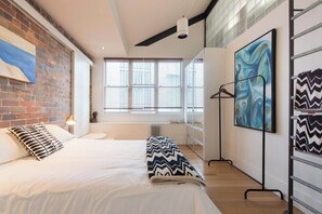 Unwind in the cosy embrace of the first king bedroom, boasting an ensuite bathroom, ample storage, and a vibrant ambience. 