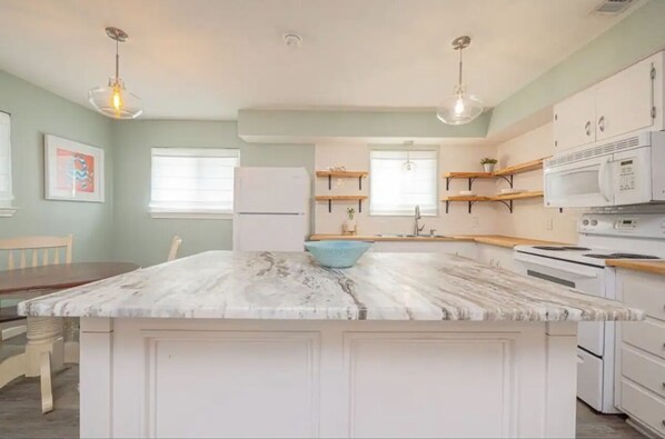 Open Kitchen to dining and living area to open up to a huge deck patio area