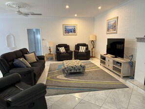 Lounge room with large smart TV including Foxtel package.