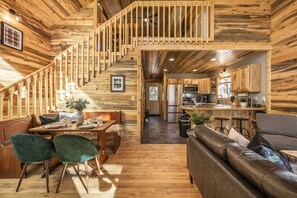 The cozy cabin is wrapped in natural beetle kill pine. Enjoy a loaded kitchen with eat-in bar, comfy living room with leather couch and 65" TV, and spacious master loft with desk area and a coffee station.