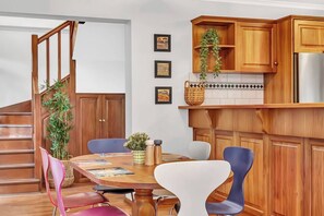 The open-plan kitchen and dining area features a six-seater table for guests to enjoy meals at home.
