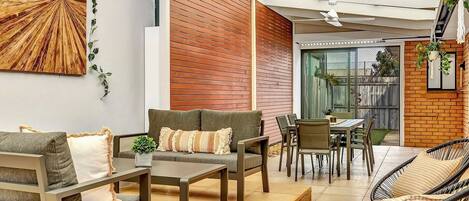 The undercover patio is spacious and stylish with plenty of seating including a six-seater dining.