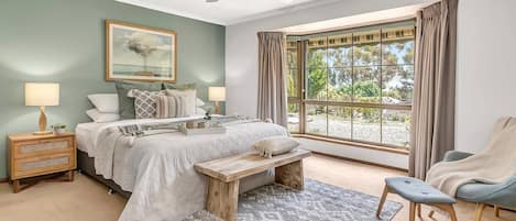 The generous master suite benefits from a king-sized bed and private ensuite bathroom.