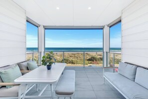 Indulge in breathtaking views and alfresco dining on the outdoor balcony, an ideal spot to unwind, soak in the scenery, and enjoy a delightful meal.