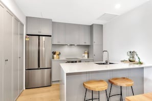 Experience culinary delights in the modern and well-equipped kitchen, perfect for both seasoned chefs and aspiring home cooks.