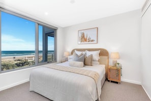 Retreat to the spacious primary bedroom, adorned with a king bed, offering mesmerising ocean views and ensuite bathroom.
