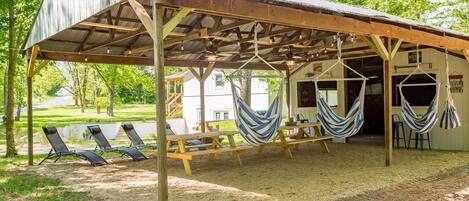 Outdoor pavilion with seating, flat screen TVS, hot tub, propane grill