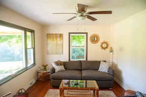 Living room off the front porch featuring a smart tv. 