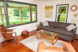 Living room off the front porch featuring a smart tv. 