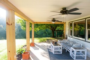 Front porch overlooking the pond. Ceiling fans are perfect for summer nights. 