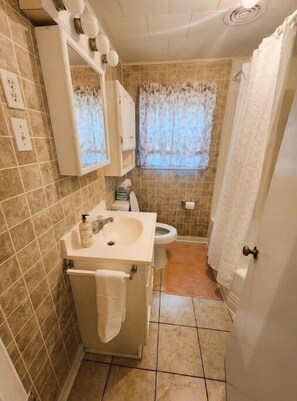 Full bath with tub/shower combo.