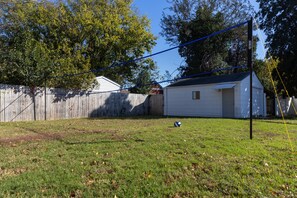 Volleyball area in the backyard with net and volleyball