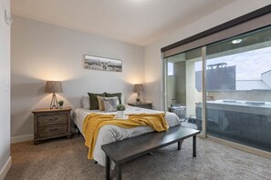 Queen en suite bedroom on entry-level with private balcony and hot tub