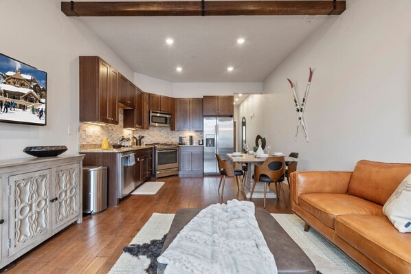 Enjoy the beautifully professionally decorated family room with heat lamps on the balcony and views of Olympic Park