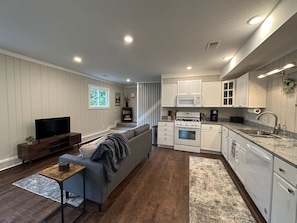 Main living area with well stocked kitchen.